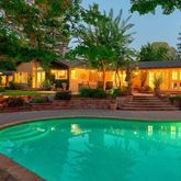a swimming pool with outdoor seating and yard