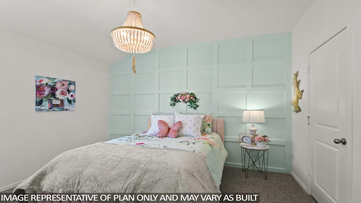 4226 Multnomah Falls Drive Conroe, TX 77303 - Photo 17 of 31 a bedroom with a bed and a chandelier