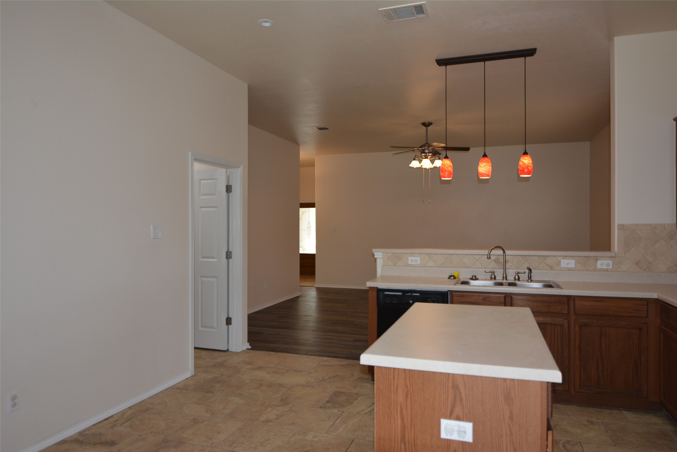 1303 Horseshoe Ranch Drive Leander, TX 78641 - Photo 26 of 26 A well-appointed kitchen features a large island and modern pendant lighting, flowing into an adjacent living area.