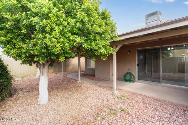 a view of a house with a backyard