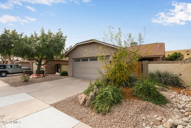 a yellow house with trees in front of it