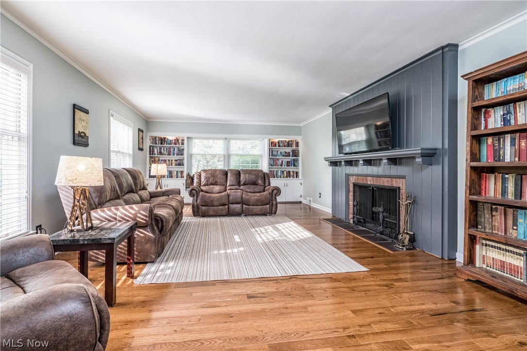 3108 Midvale Road Northwest Canton, OH 44718 - Photo 5 of 21 A spacious and well lit living room with fireplace and hardwood floors.