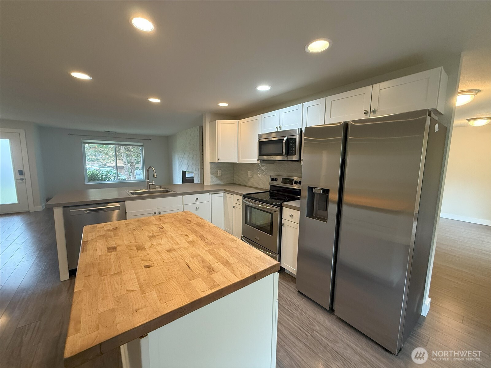 8820 Prentice Avenue Gig Harbor, WA 98332 - Photo 5 of 13 a kitchen with stainless steel appliances granite countertop a refrigerator and a stove top oven