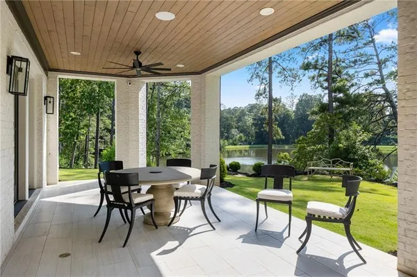 a patio with yard glass top table and chairs
