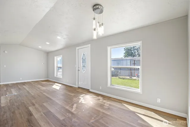 an empty room with windows and entrance