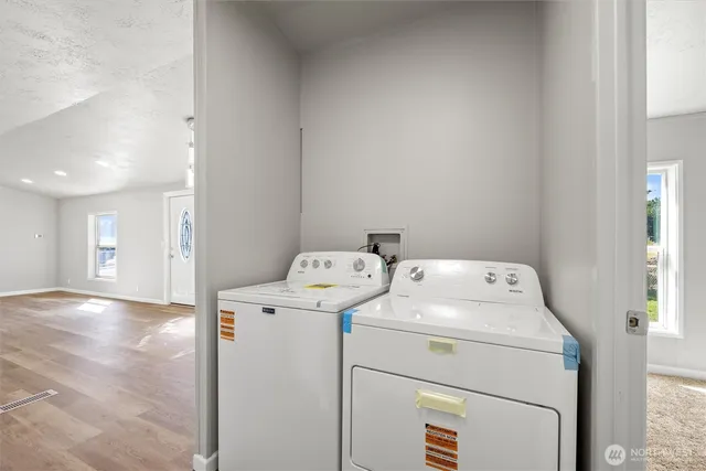 a view of storage and utility room with washer and dryer