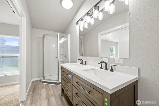 a bathroom with a sink a mirror and a shower