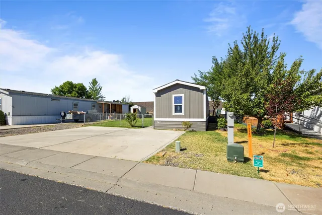 a front view of a house with a yard garage and outdoor seating