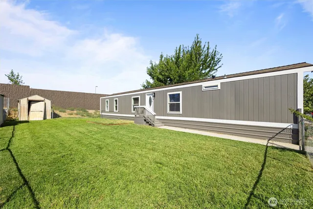 a house view with a sitting space and garden