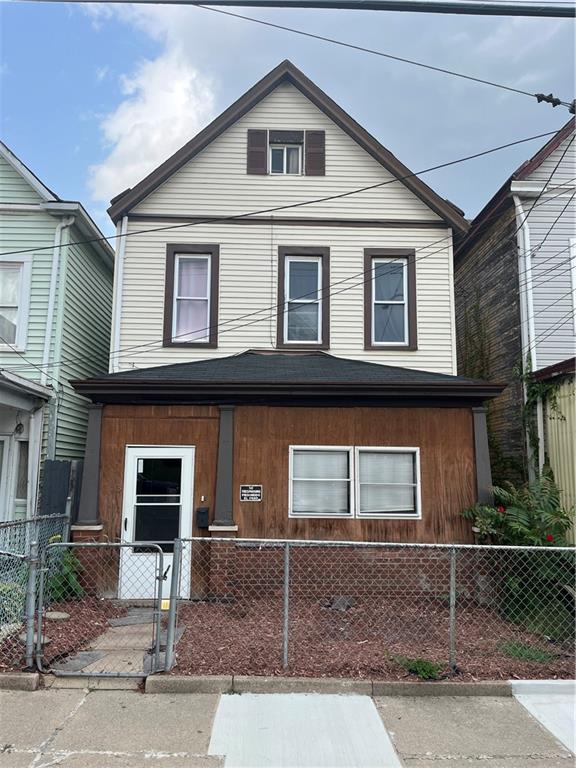 a view of a white house with large windows