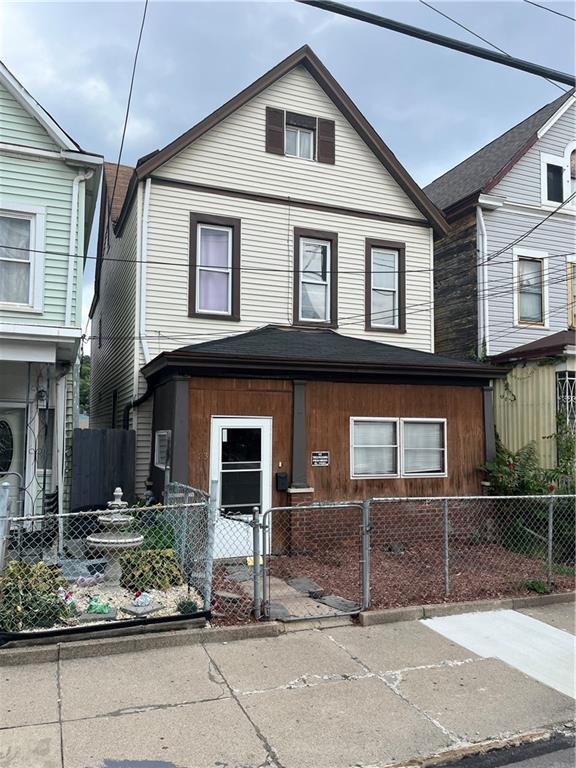 213 Comrie Avenue Braddock, PA 15104 - Photo 2 of 2 a front view of a house with garden