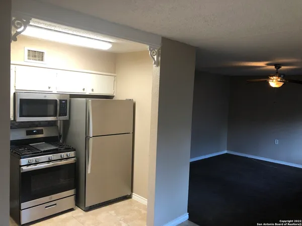 a kitchen with a refrigerator and a stove
