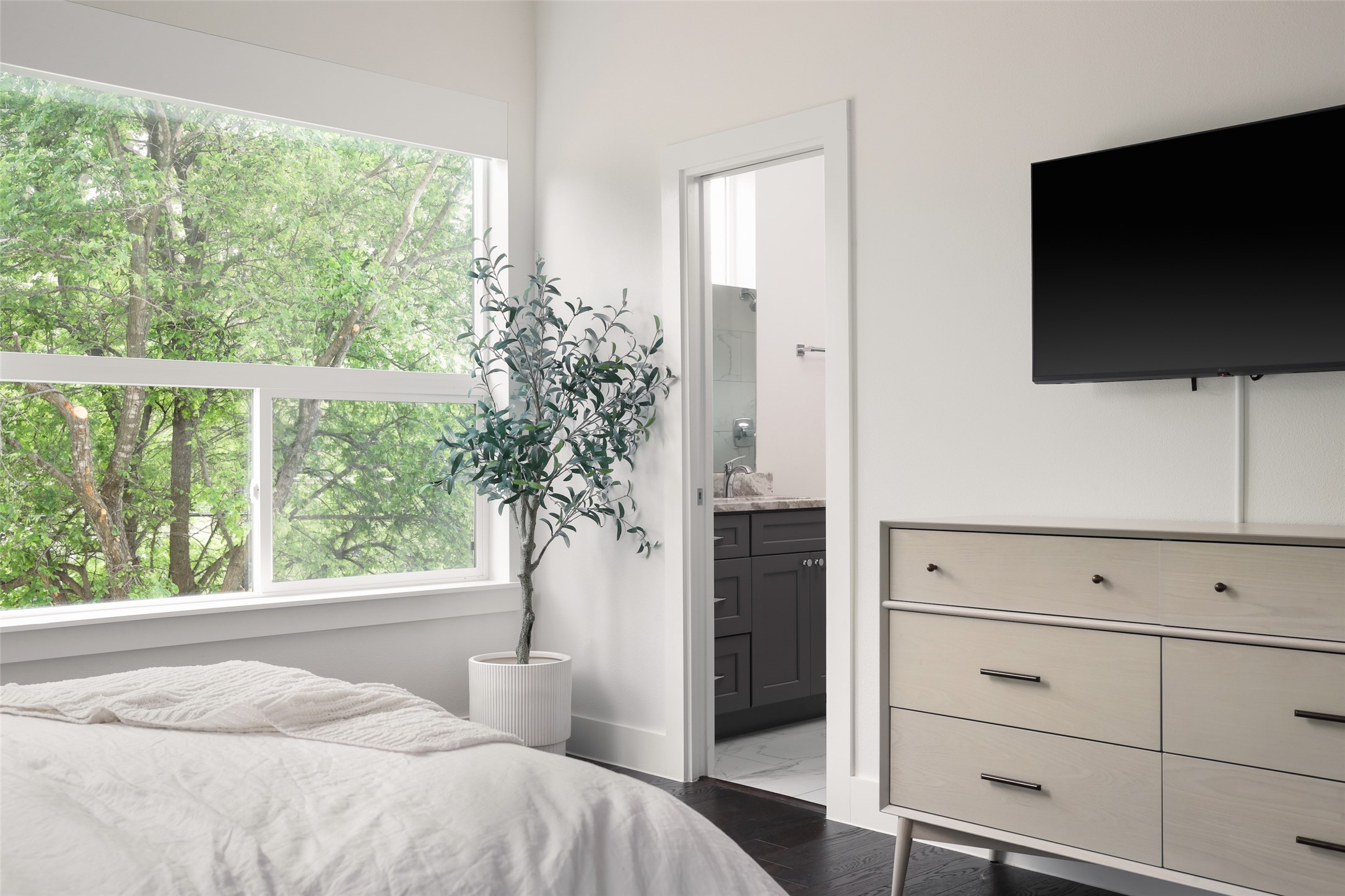 1120 Omega Avenue, Unit 1 Austin, TX 78721 - Photo 12 of 24 a bedroom with a bed and a flat screen tv