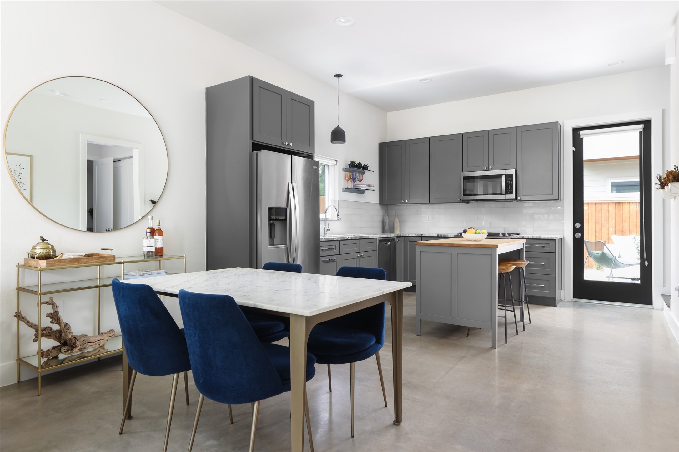 1120 Omega Avenue, Unit 1 Austin, TX 78721 - Photo 2 of 24 a open kitchen with stainless steel appliances kitchen island a table chairs and a refrigerator