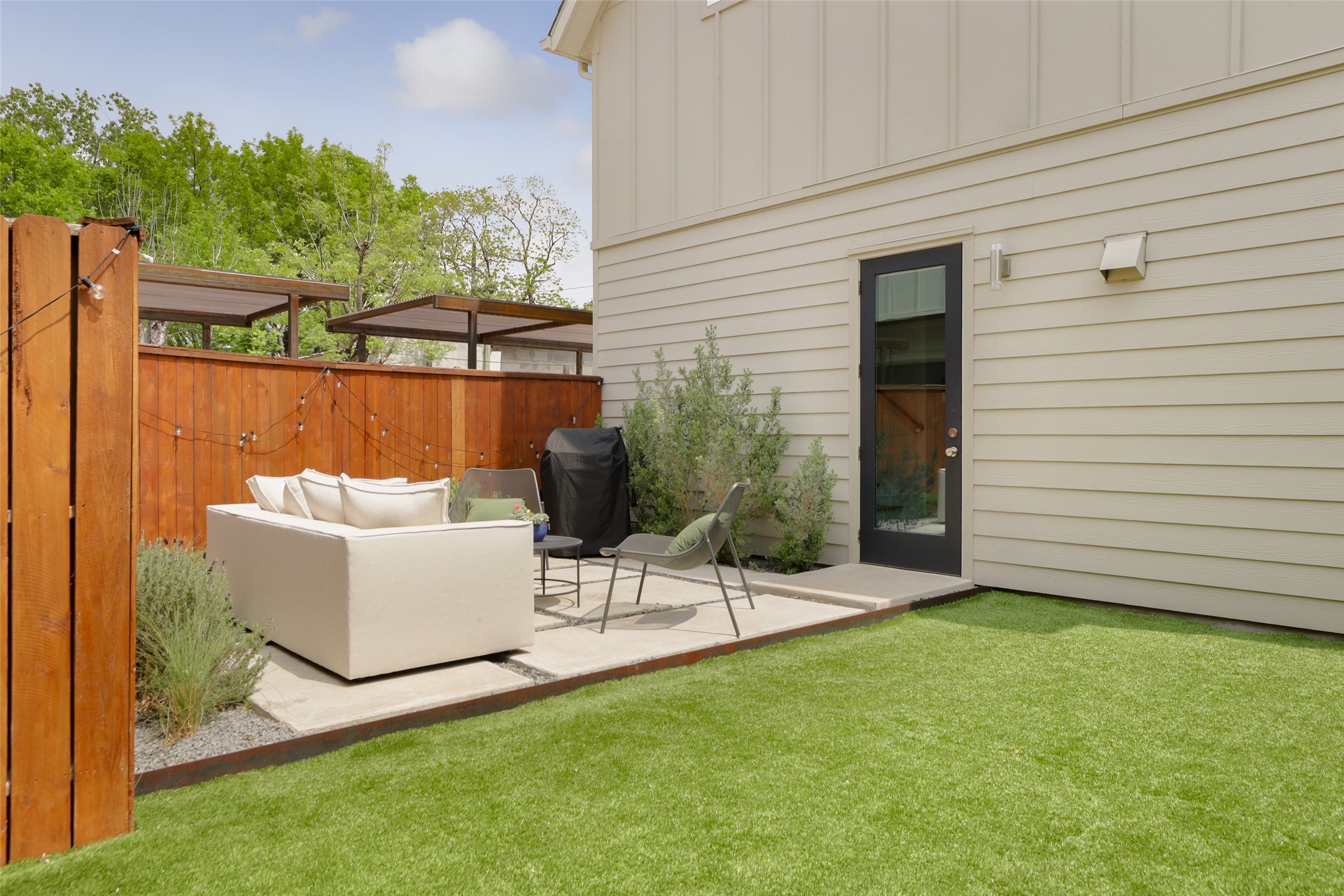 1120 Omega Avenue, Unit 1 Austin, TX 78721 - Photo 22 of 24 a view of a patio with a chairs and table in the patio