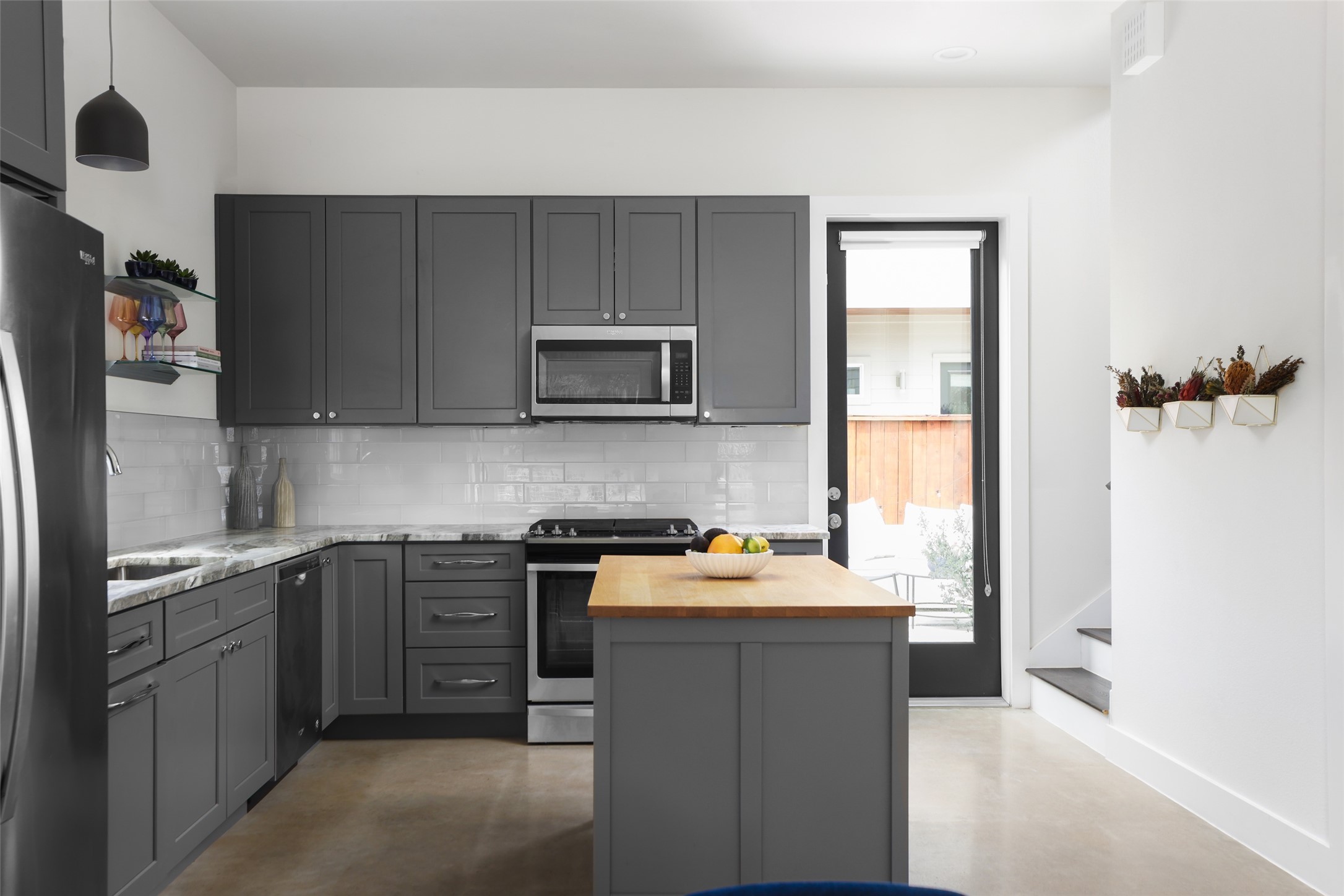 1120 Omega Avenue, Unit 1 Austin, TX 78721 - Photo 3 of 24 a kitchen with a sink a stove and cabinets