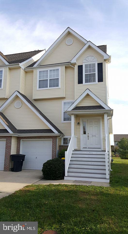 335 Paradee Drive Dover, DE 19904 - Photo 2 of 45 a front view of a house with a yard and garage