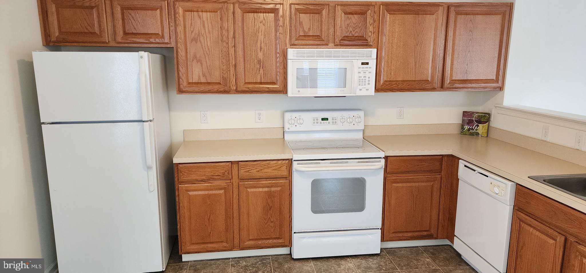 335 Paradee Drive Dover, DE 19904 - Photo 22 of 45 a kitchen with stainless steel appliances white cabinets and a refrigerator with a sink