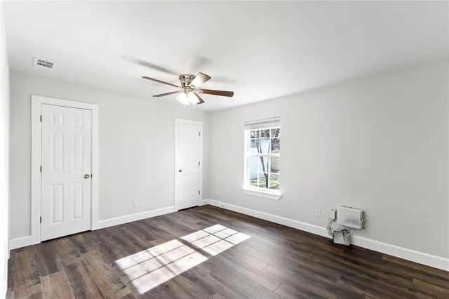 a living room with furniture a rug and a flat screen tv