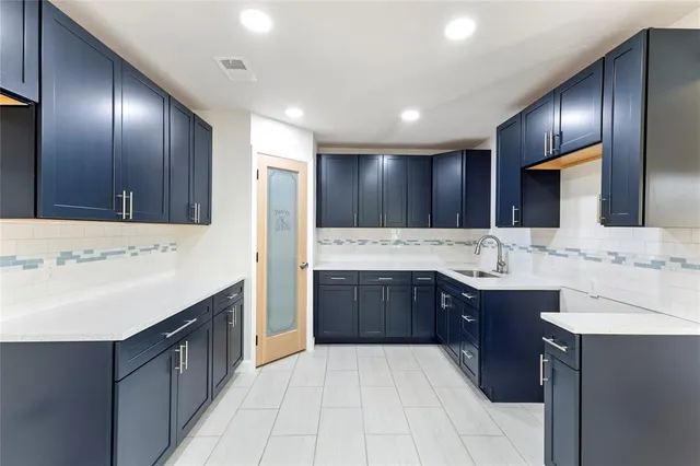 a view of kitchen with wooden floor and electronic appliances