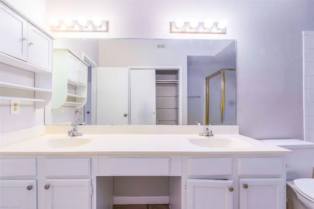 a bathroom with a sink vanity and a mirror