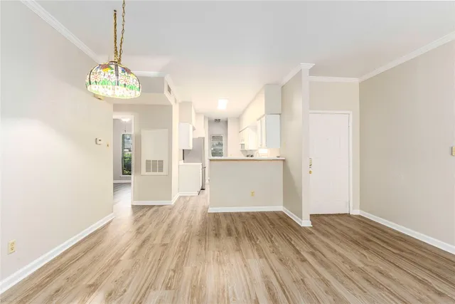 a view of a room with wooden floor