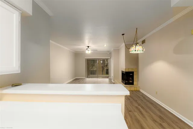 a large white bed in a room next to a window