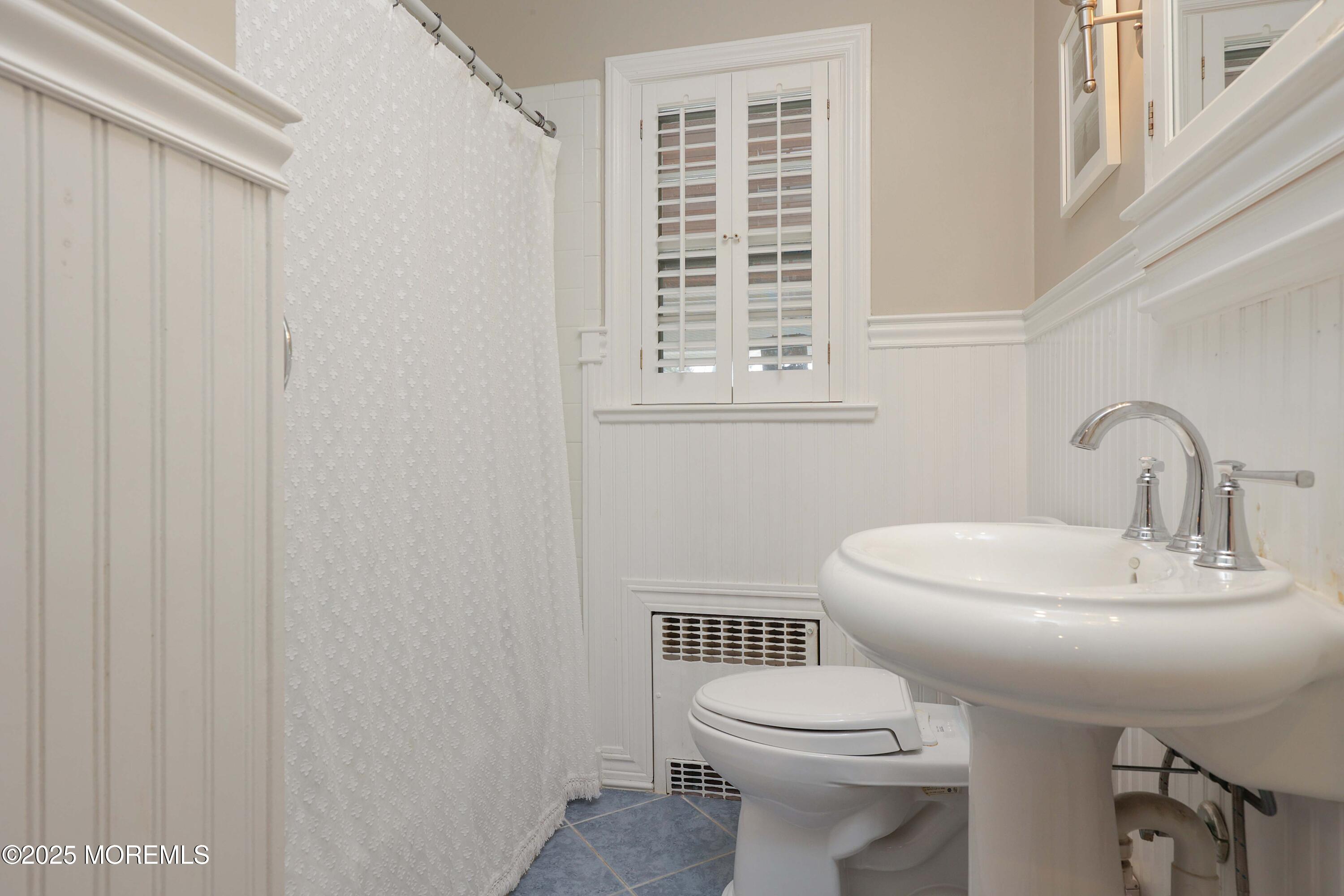 29 SilverWhite Road Little Silver, NJ 07739 - Photo 14 of 38 a bathroom with a sink a toilet and a window
