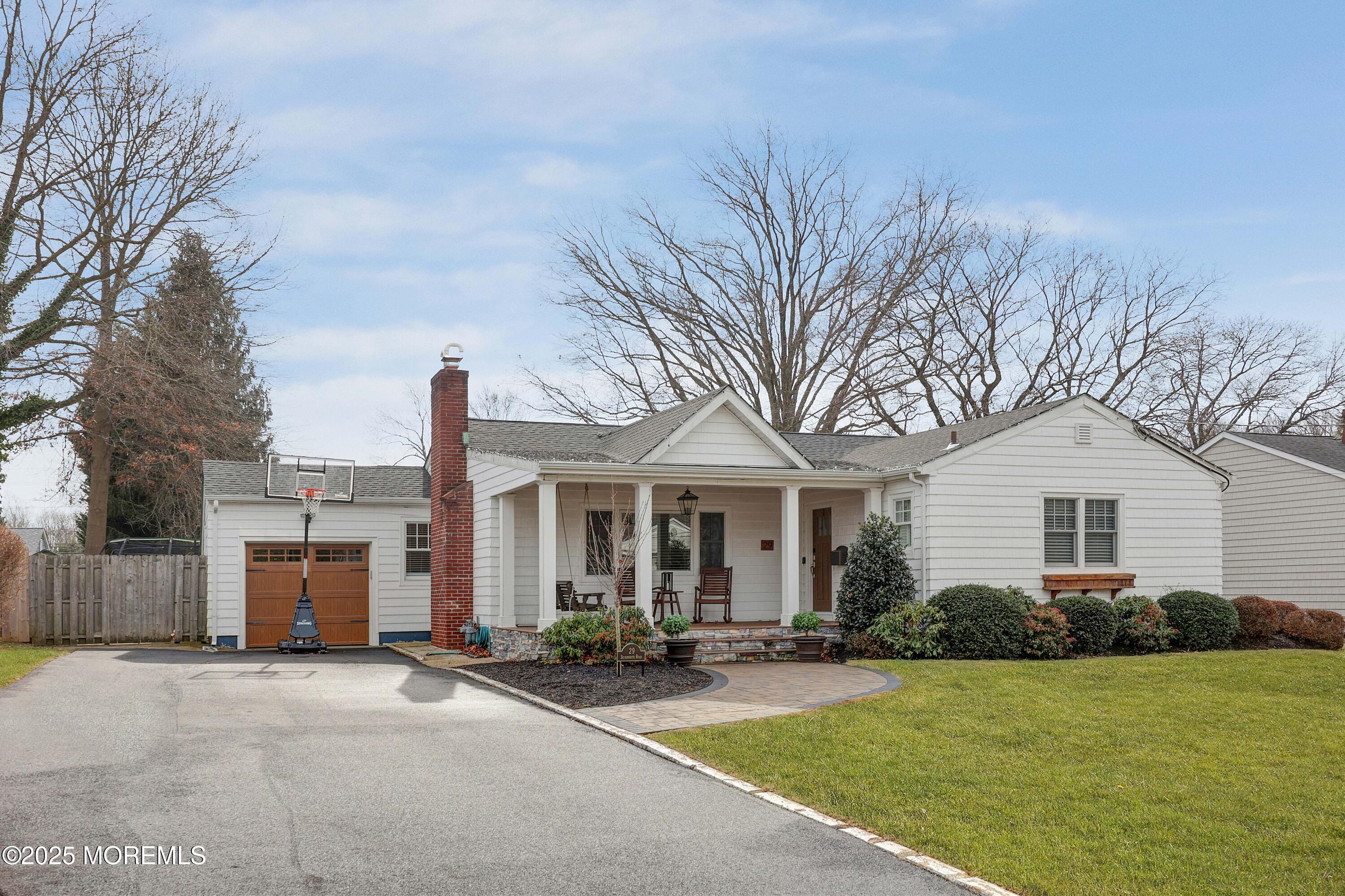 29 SilverWhite Road Little Silver, NJ 07739 - Photo 28 of 38 a front view of a house with a yard and garage