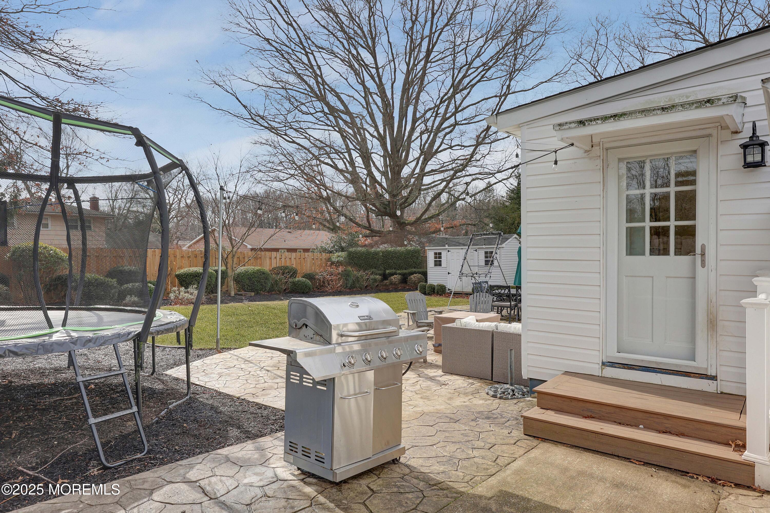 29 SilverWhite Road Little Silver, NJ 07739 - Photo 31 of 38 a view of a patio with a table chairs and a fire pit