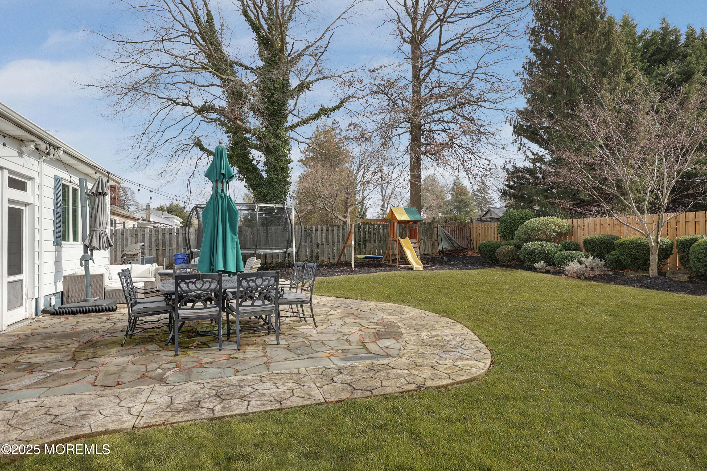 29 SilverWhite Road Little Silver, NJ 07739 - Photo 36 of 38 a view of a house with a yard patio and fire pit