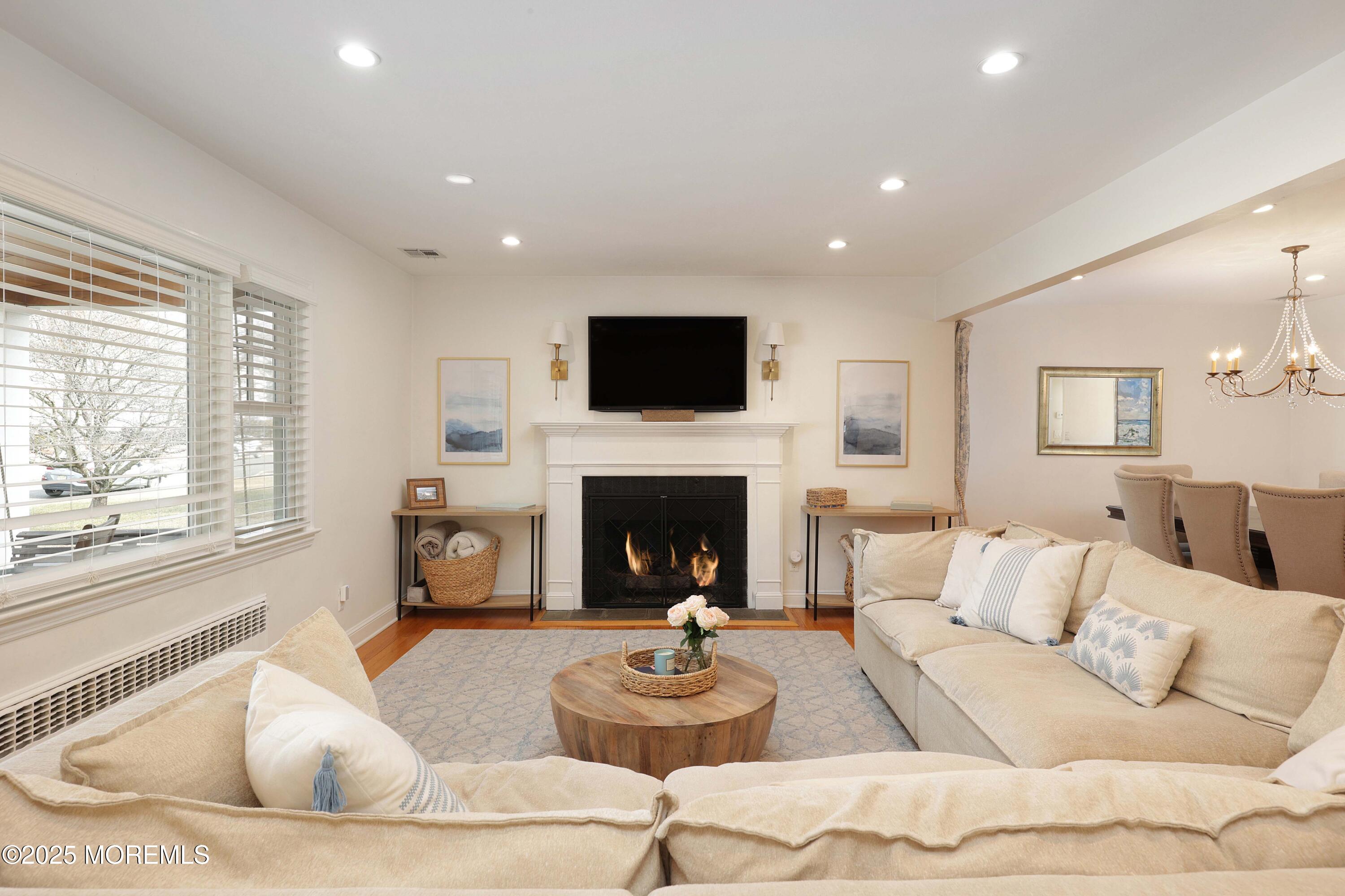 29 SilverWhite Road Little Silver, NJ 07739 - Photo 5 of 38 a living room with furniture a fireplace and a flat screen tv