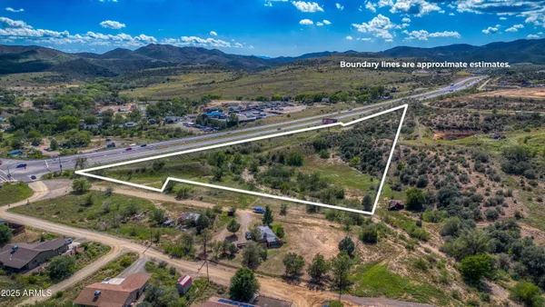a view of a yard in front of a house with a floor to ceiling window