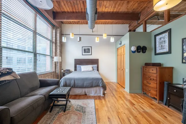 a bedroom with a bed and a couch