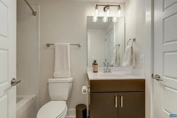 a bathroom with a sink mirror toilet and bathtub