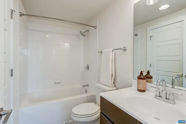 an aerial view of a residential building with parking