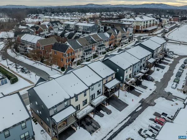 a view of a house with a barbeque and wooden stairs