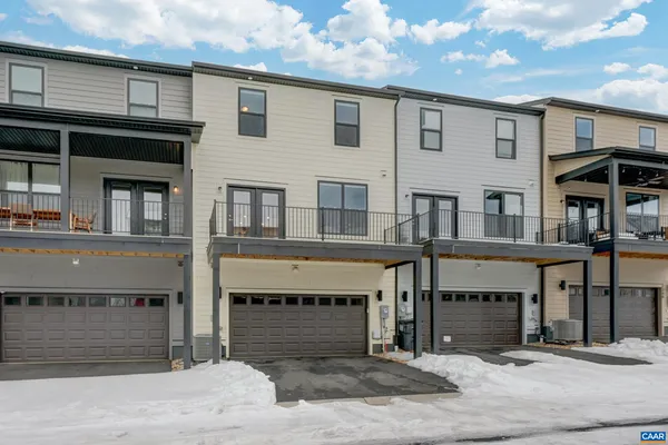 a front view of a house with a road