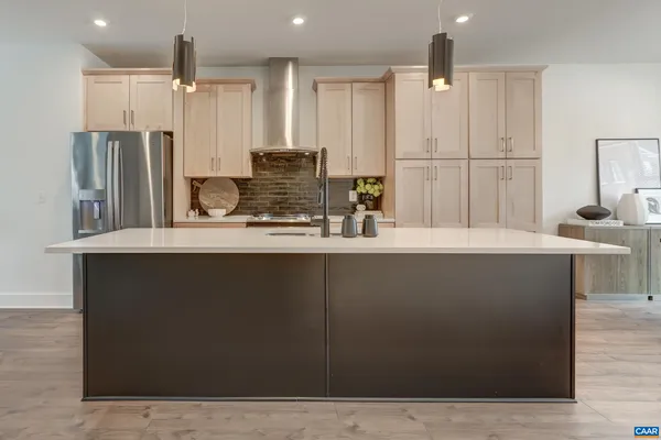 a kitchen with kitchen island cabinets and refrigerator