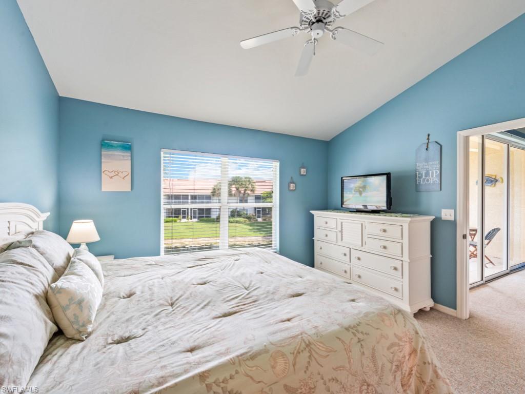 4970 Deerfield Way, Unit F202 Naples, FL 34110 - Photo 11 of 19 a bedroom with a large bed and a window