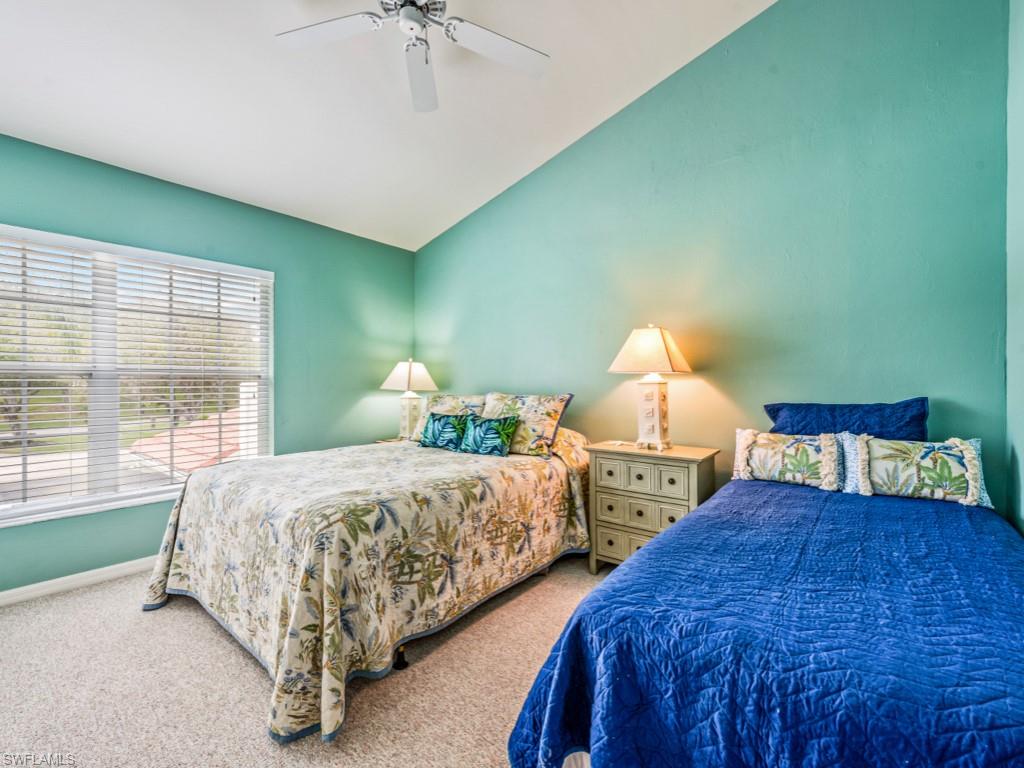 4970 Deerfield Way, Unit F202 Naples, FL 34110 - Photo 13 of 19 a bedroom with two beds and large window