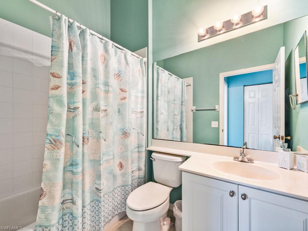 4970 Deerfield Way, Unit F202 Naples, FL 34110 - Photo 15 of 19 a bathroom with a sink a toilet and shower