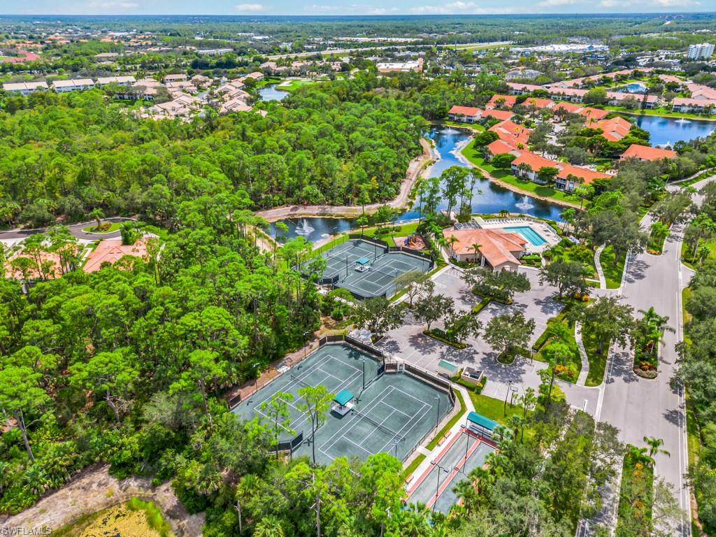 4970 Deerfield Way, Unit F202 Naples, FL 34110 - Photo 17 of 19 an aerial view of residential houses with outdoor space and trees