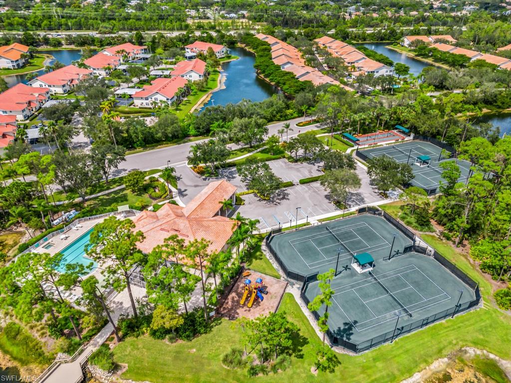 4970 Deerfield Way, Unit F202 Naples, FL 34110 - Photo 18 of 19 an aerial view of residential houses with outdoor space and trees