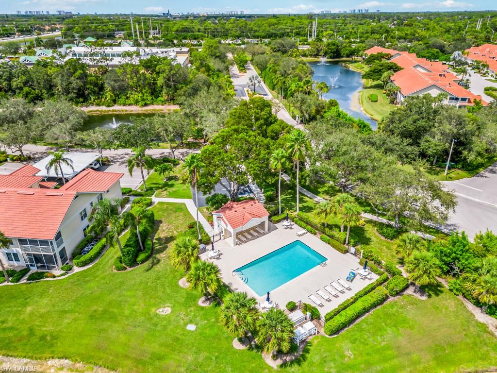 4970 Deerfield Way, Unit F202 Naples, FL 34110 - Photo 19 of 19 an aerial view of a house with a garden and lake view