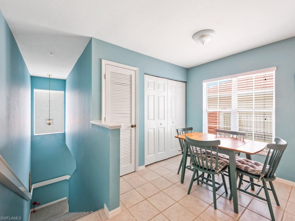 4970 Deerfield Way, Unit F202 Naples, FL 34110 - Photo 5 of 19 a view of a dining room with furniture and a window