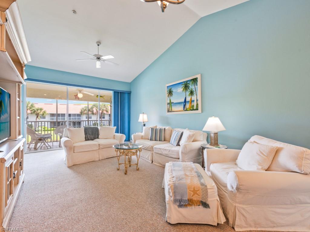 4970 Deerfield Way, Unit F202 Naples, FL 34110 - Photo 7 of 19 a living room with furniture and a large window