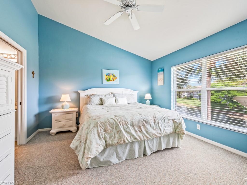 4970 Deerfield Way, Unit F202 Naples, FL 34110 - Photo 10 of 19 a bedroom with a bed and window