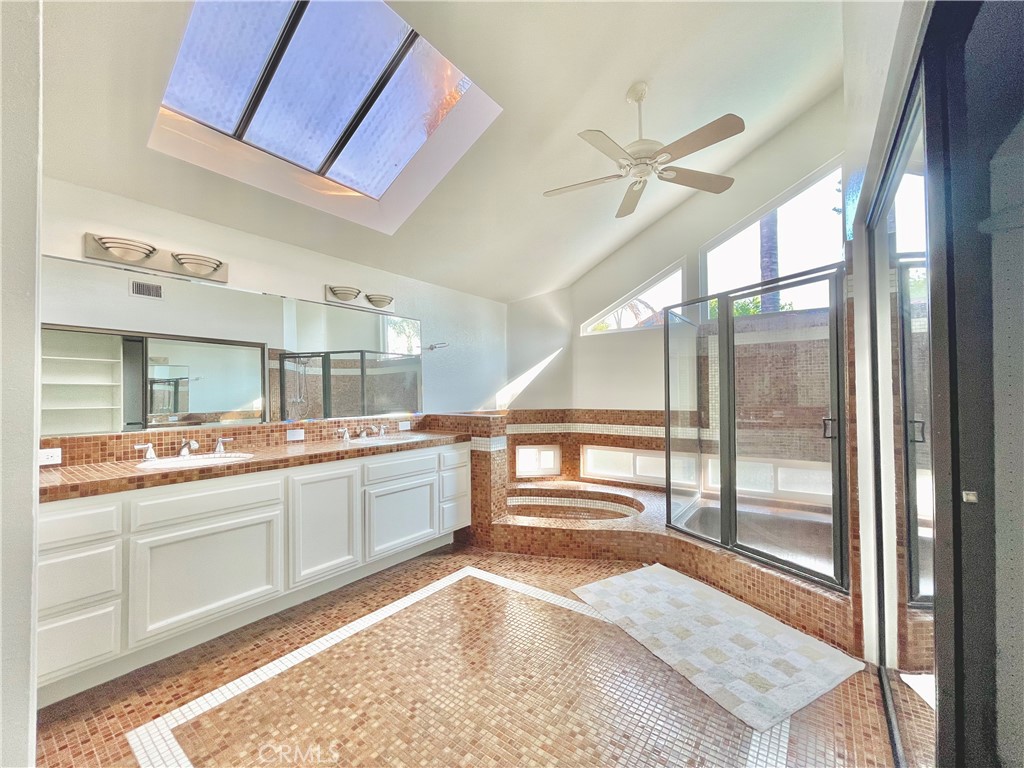 10 Ramada Irvine, CA 92620 - Photo 16 of 22 a large kitchen with kitchen island a large window a sink and stainless steel appliances
