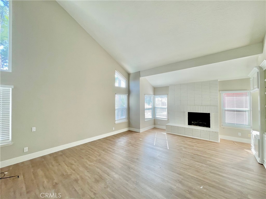 10 Ramada Irvine, CA 92620 - Photo 17 of 22 a view of a livingroom with wooden floor and a fireplace